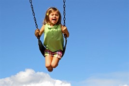 playground child on swing
